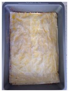 Top with 2 sheets of filo, buttering between each layer
